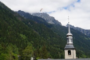 The gliders float effortlessly from the mountaintops pas the church steeple in the centre of town