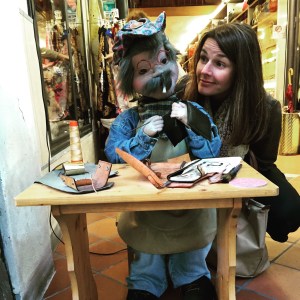 Astrid watching a local leather craftsman work.